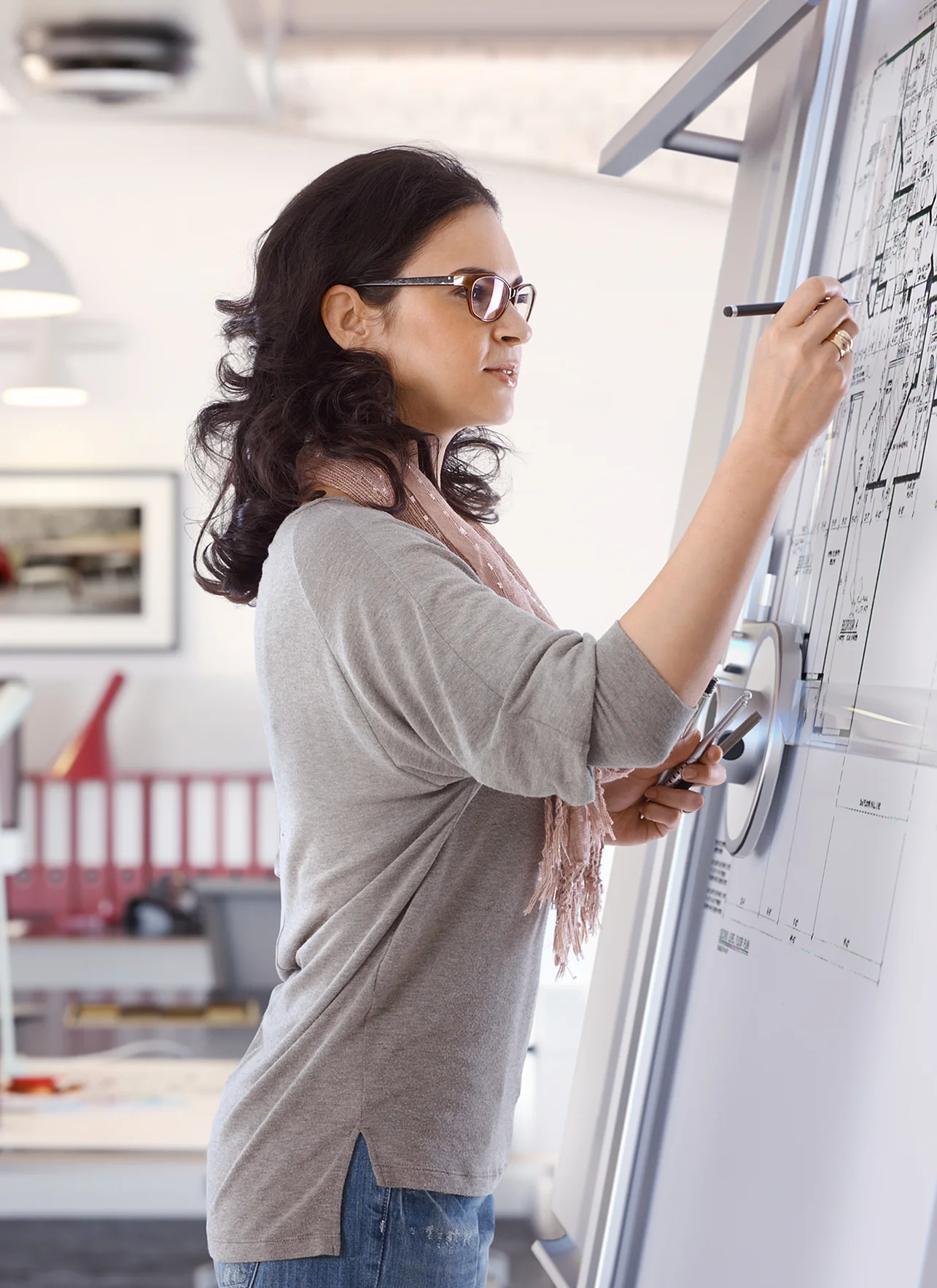 adult woman busy drawing plan at architect business office on drawing board adult woman busy drawing plan at architect business office on drawing board