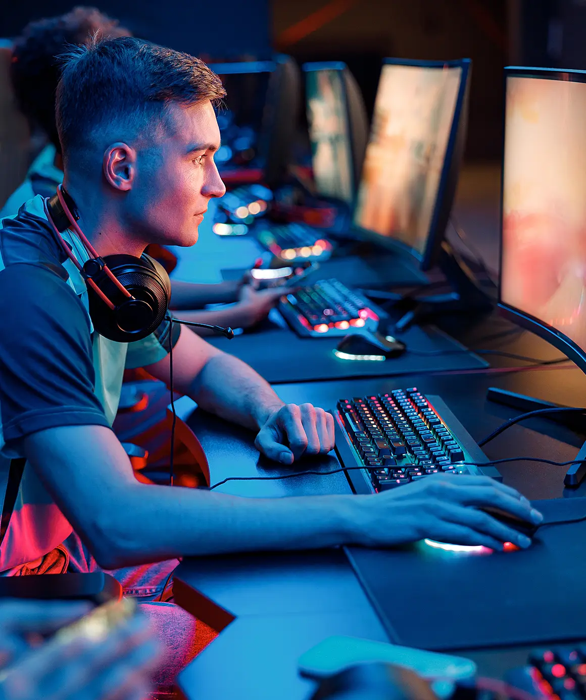 side view of focused professional cybersport gamer playing online game on pc