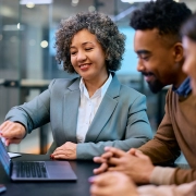 smiling financial consultant and african american couple analyzing their investments