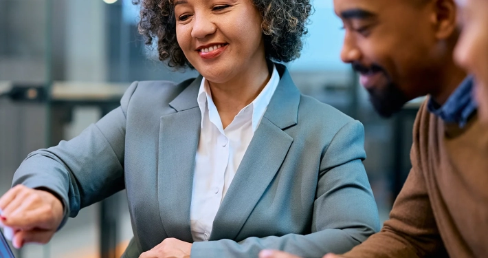 smiling financial consultant and african american couple analyzing their investments