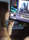 woman video montager mounts video at desktop