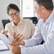 working using digital tablet discussing financial marketing strategy