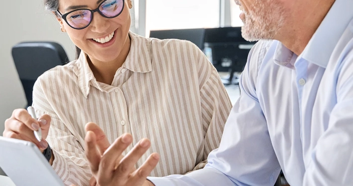 working using digital tablet discussing financial marketing strategy