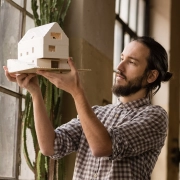 young architect is looking on the new model in the old industrial space